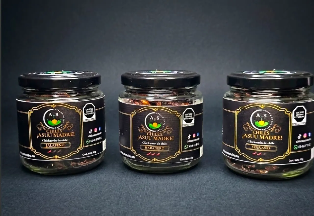 The three jars of Sabores chili crunch lined up together, showing the variety of colors from green to red, professional studio product shot