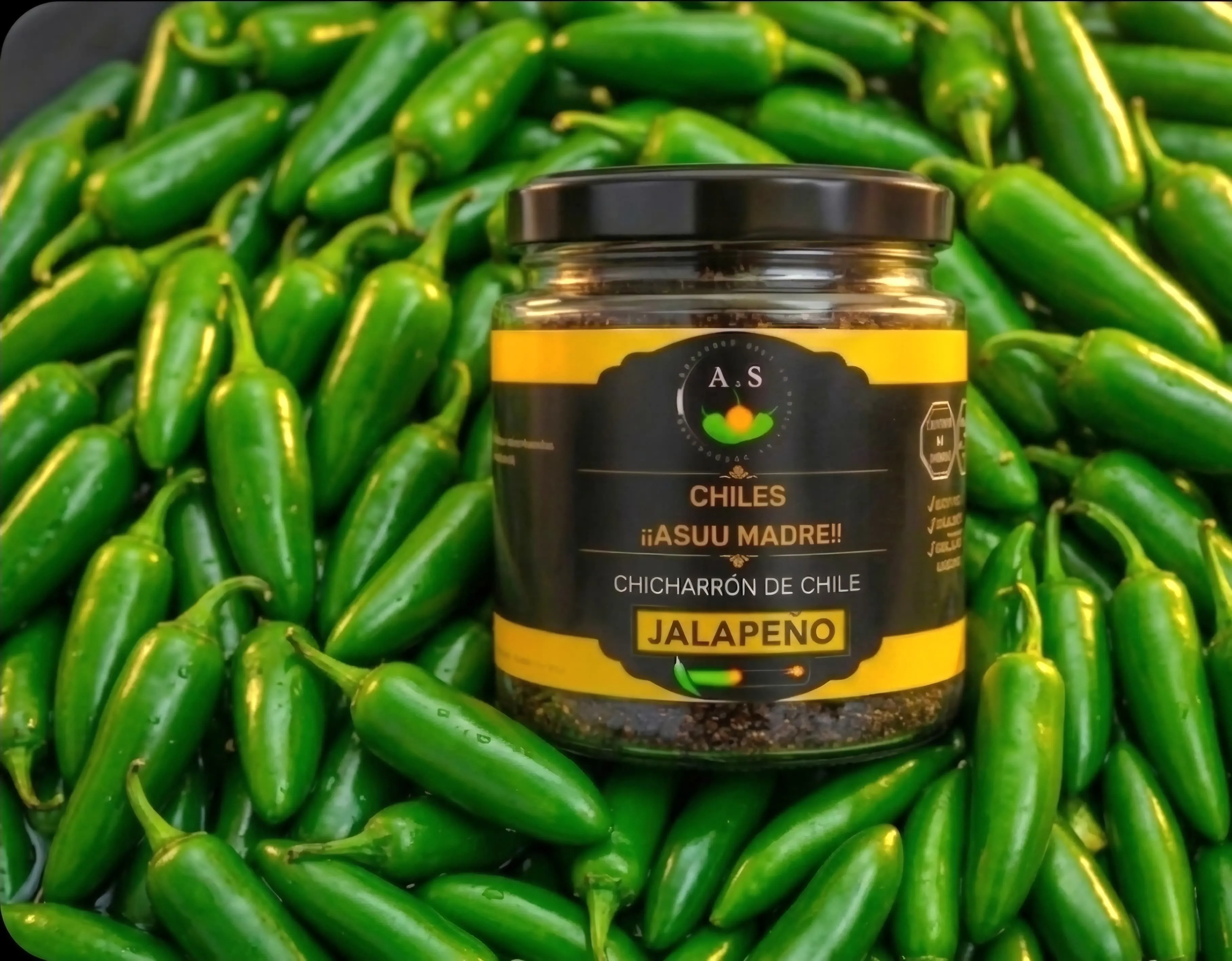 Close-up of fresh green jalapeño peppers with water droplets on a dark textured slate background, professional culinary photography