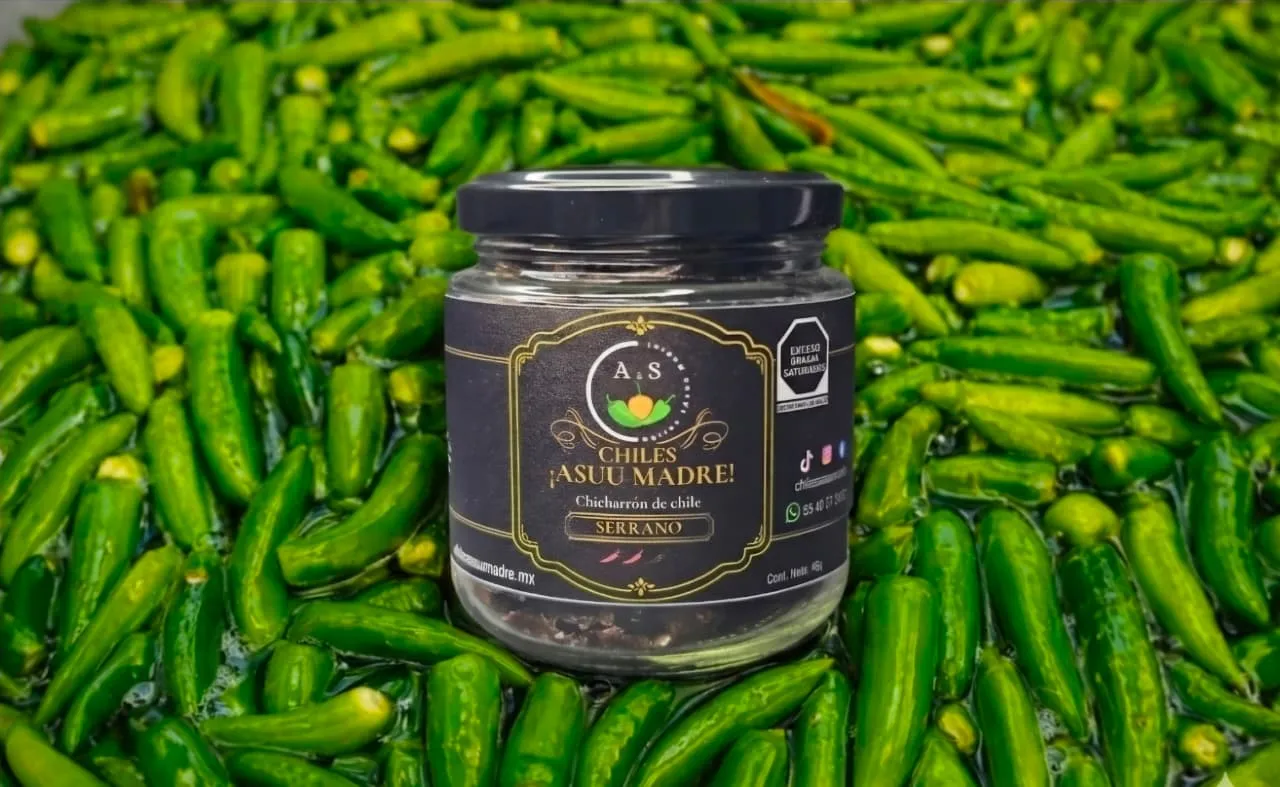 Gourmet artisanal chili crunch jar with oil and seeds visible, dramatic lighting highlighting the texture and golden oil